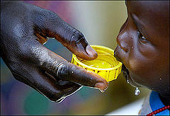 Photo of small child being fed, from Sudan Watch web site Photo of small child being fed, from Sudan Watch web site