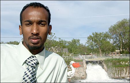 Photo credit: MinnPost photo by Sharon Schmickle Abdirashid Nuur stands near the namesake statue and waterfalls in his new home. Photo credit: MinnPost photo by Sharon Schmickle Abdirashid Nuur stands near the namesake statue and waterfalls in his new home.