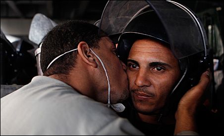 Photo credit: REUTERS/Amr Abdallah Dalsh; Description: A protester kisses a police officer during a demonstration in Cairo. Photo credit: REUTERS/Amr Abdallah Dalsh; Description: A protester kisses a police officer during a demonstration in Cairo.