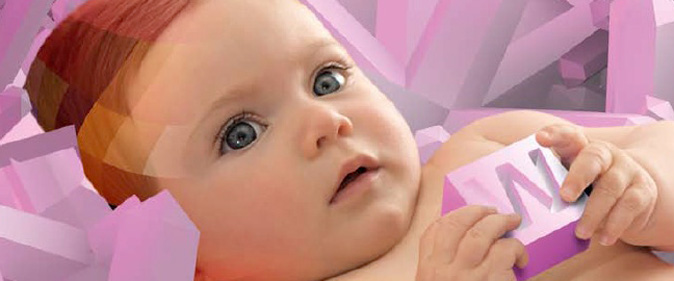 Photo of a baby holding a W alphabet block.  credit:  Steven Seal and Nick Wilson