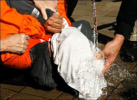 Photo credit: REUTERS/Kevin Lamarque; Description: Demonstrator Maboud Ebrahimzadeh is held down during a simulation of waterboarding outside the Justice Department in Washington, D.C., in 2007. Photo credit: REUTERS/Kevin Lamarque; Description: Demonstrator Maboud Ebrahimzadeh is held down during a simulation of waterboarding outside the Justice Department in Washington, D.C., in 2007.