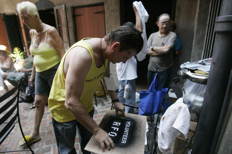 Residents of the Faubourg Marigny neighborhood of New Orleans printed T-shirts during a community meeting on Sept. 9, 2005. The neighborhood organized a cleanup effort even as mandatory evacuation of the city was under way. Refusing to obey the order to evacuate, many residents remained in their houses. Photo credit: Hector Mata/AFP/Getty Images Residents of the Faubourg Marigny neighborhood of New Orleans printed T-shirts during a community meeting on Sept. 9, 2005. The neighborhood organized a cleanup effort even as mandatory evacuation of the city was under way. Refusing to obey the order to evacuate, many residents remained in their houses. Photo credit: Hector Mata/AFP/Getty Images